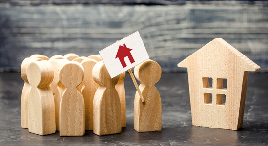 Wooden figures near a wooden house