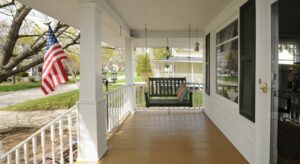 Swing on front porch next to American flag